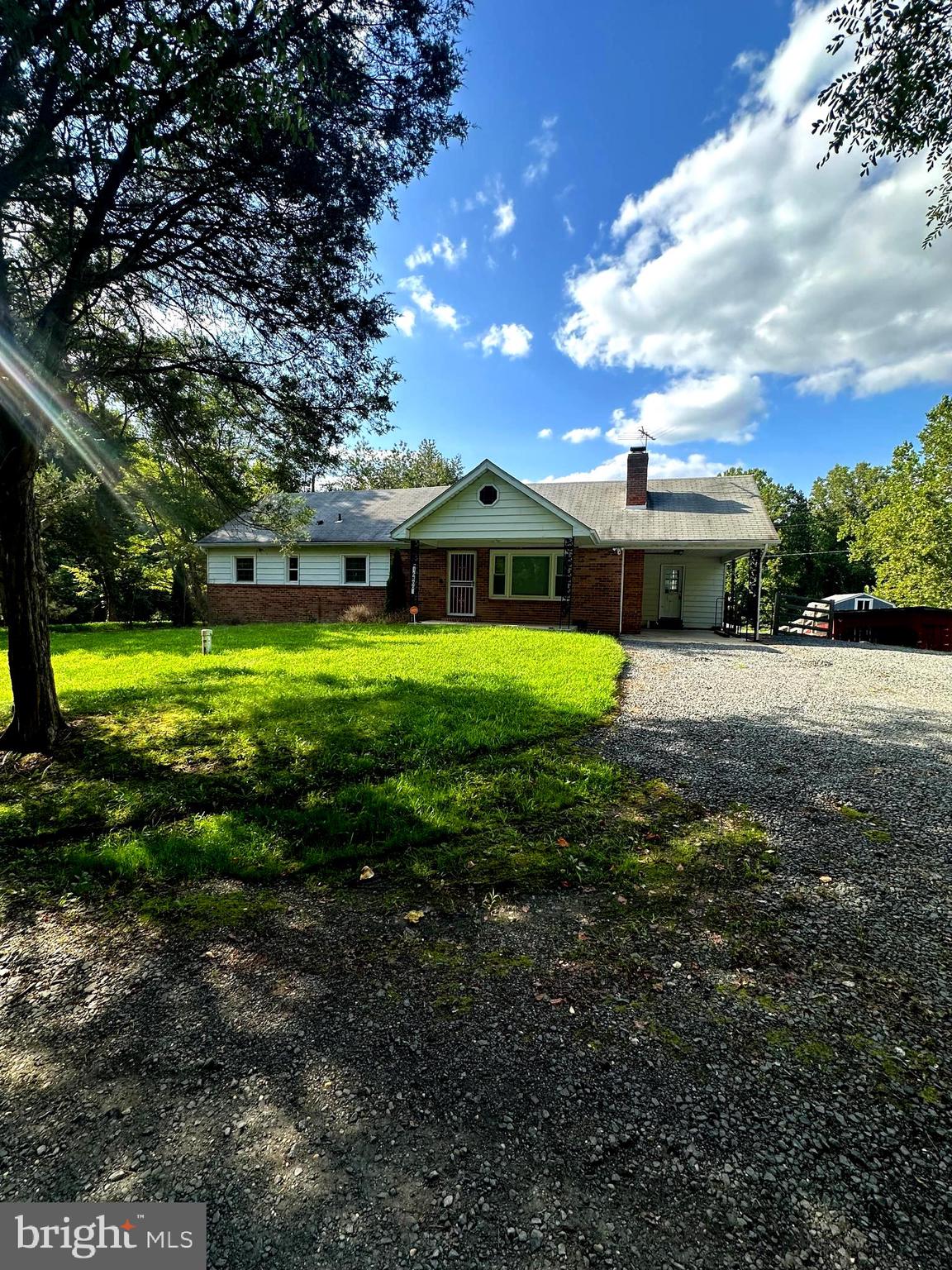 a view of a big yard with a house in the background