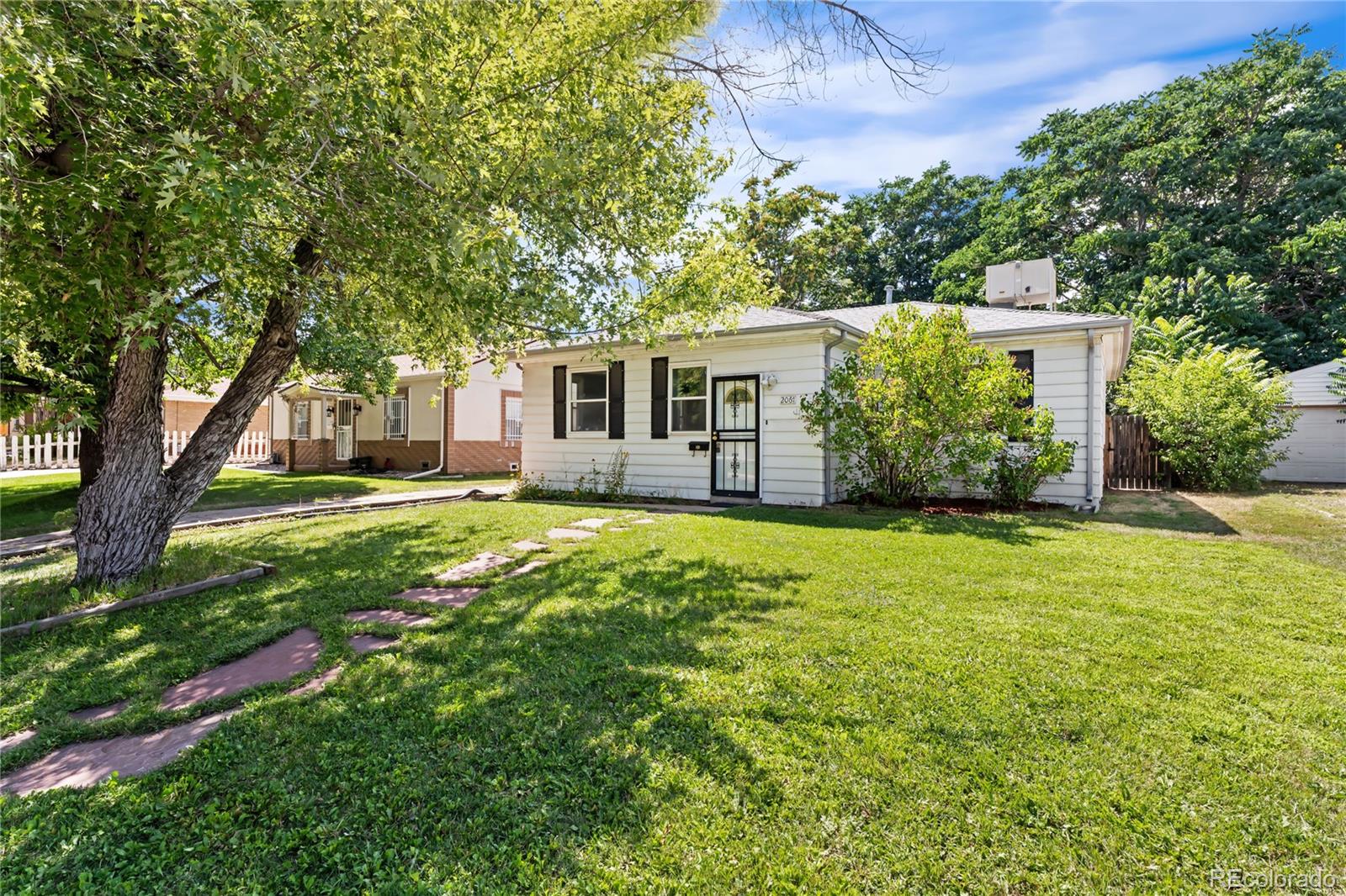 a front view of house with yard and green space