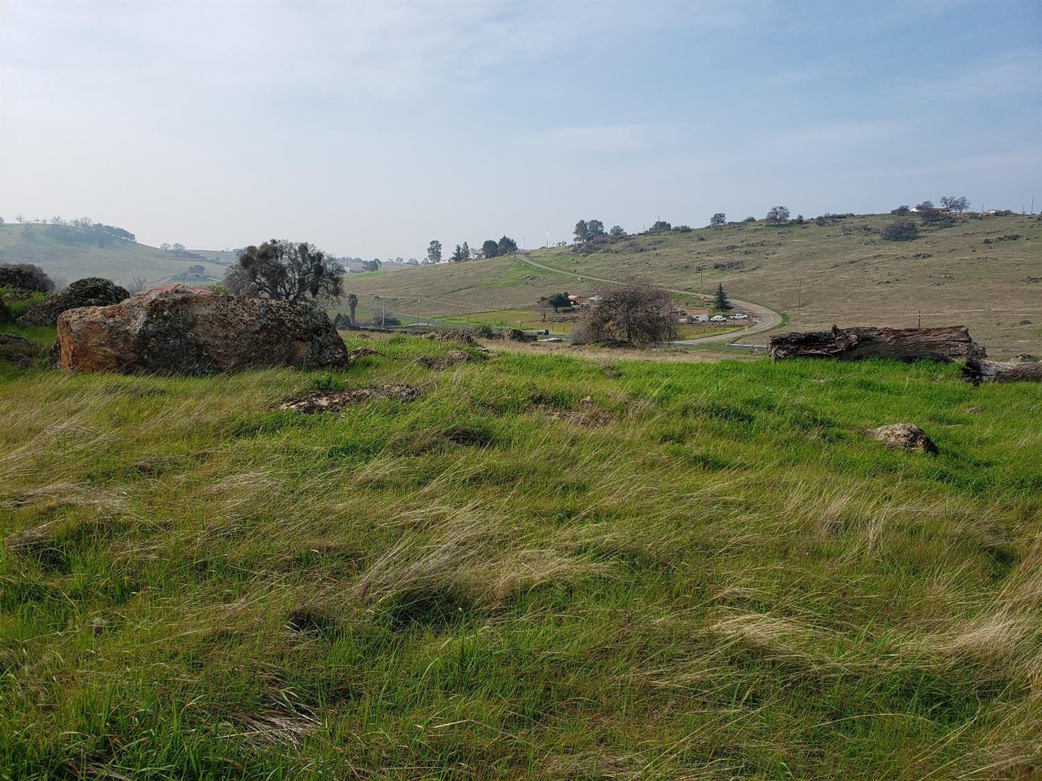 a view of a lake and green valley