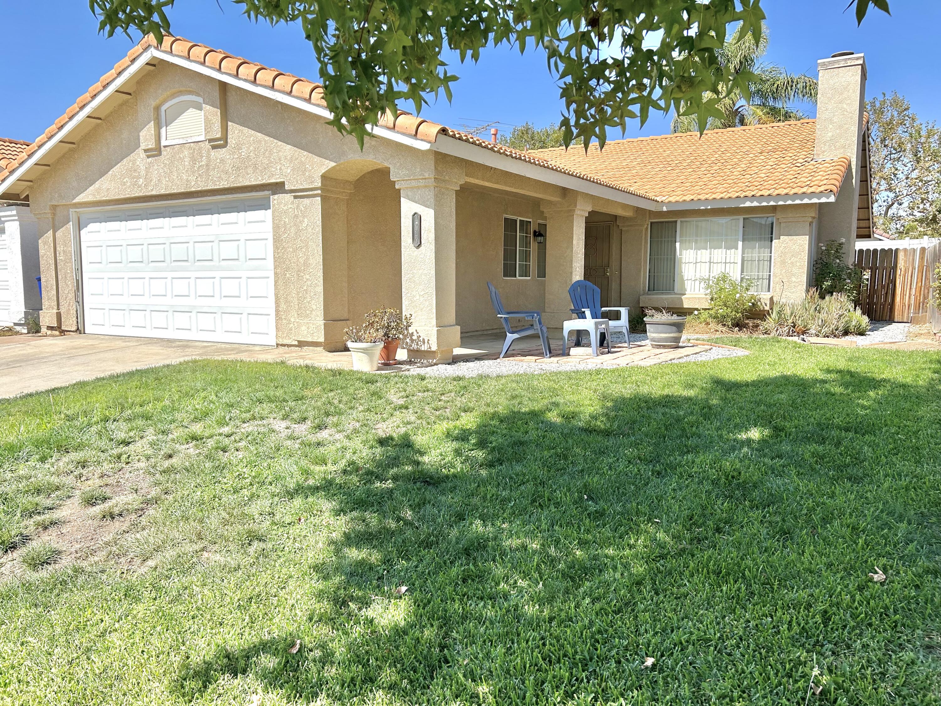 a view of a house with backyard porch and garden