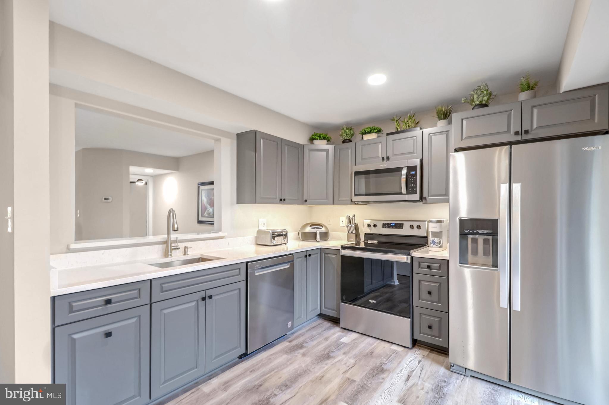 a kitchen with stainless steel appliances granite countertop a refrigerator and a sink