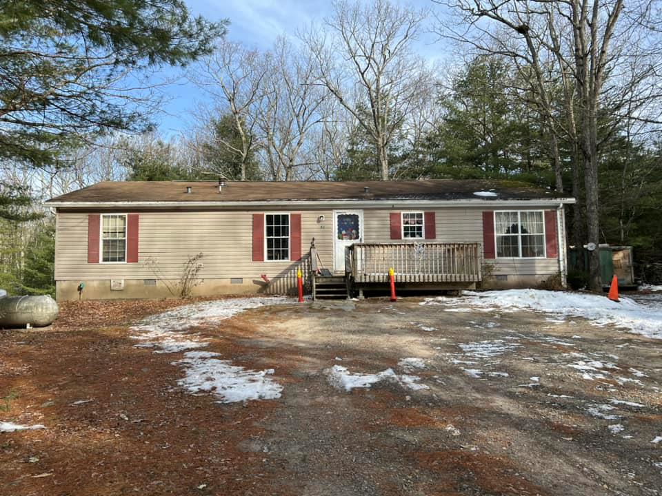 a view of a house with backyard and a tree