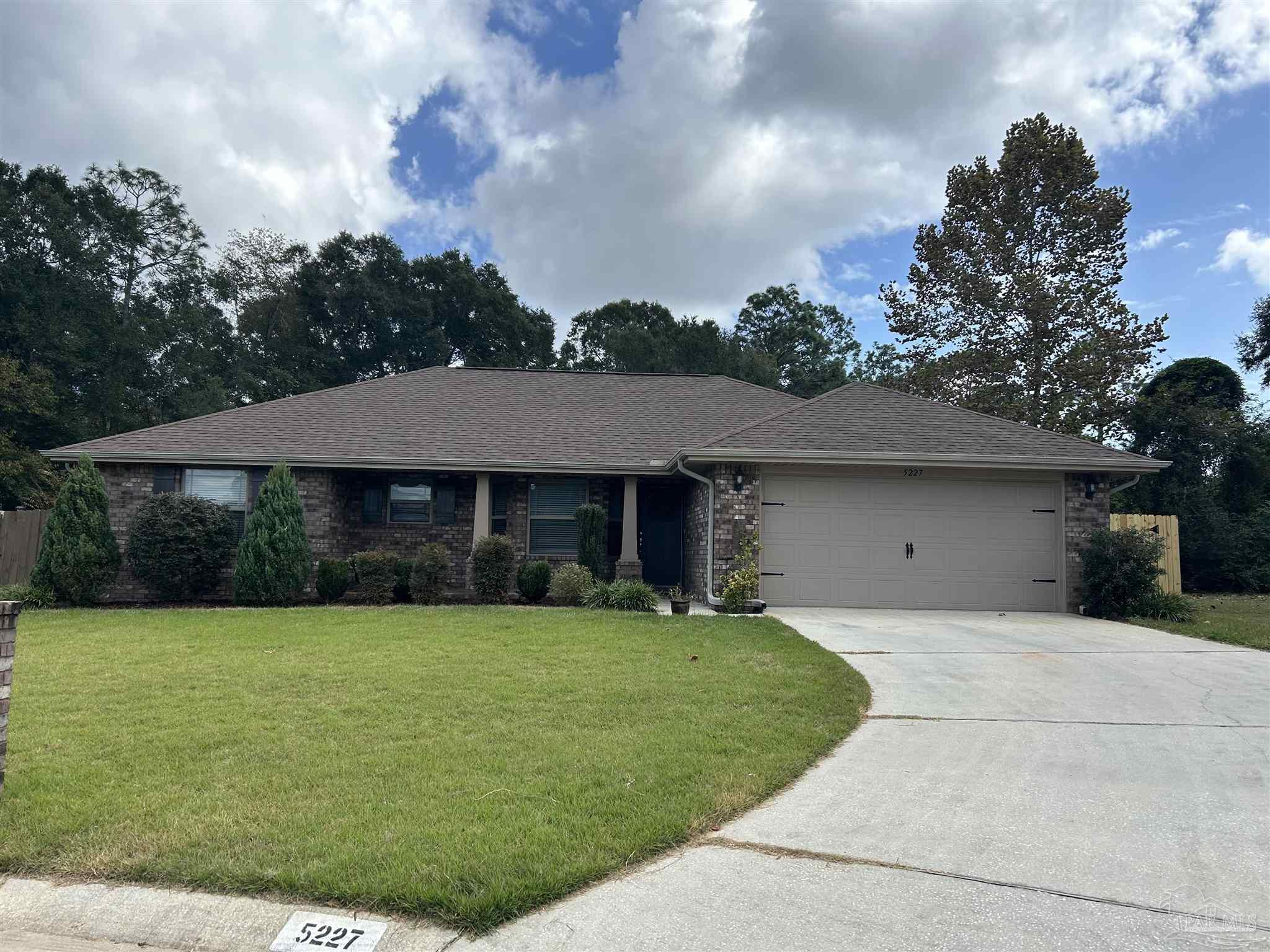 a front view of a house with yard