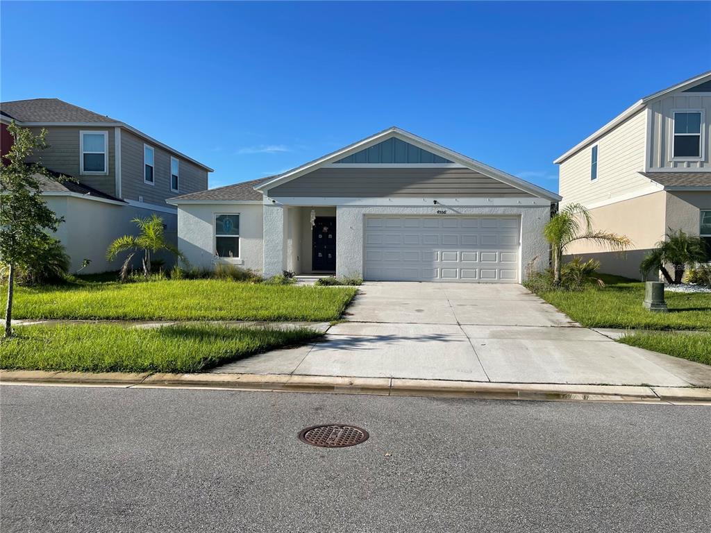 a front view of a house with a yard and garage