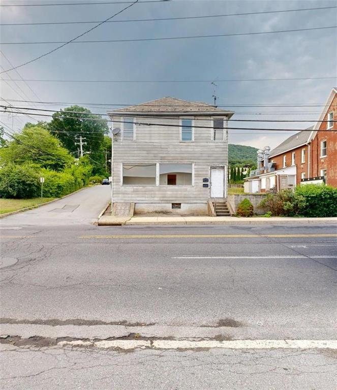 a view of building with car parked