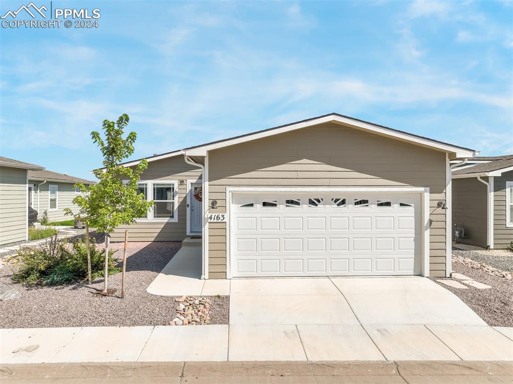 a front view of a house with garage