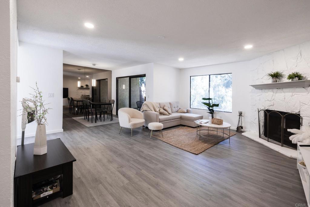 a living room with furniture a fireplace and a window