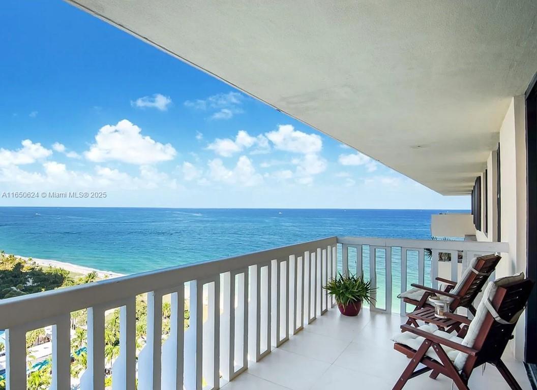 a balcony with table and chairs