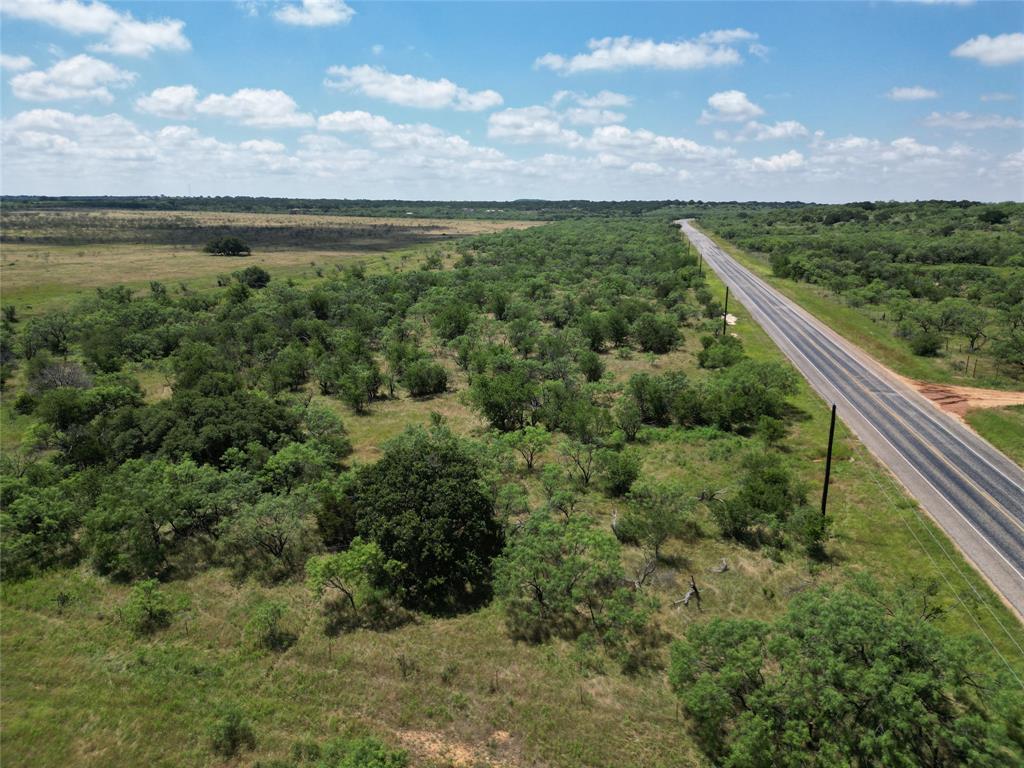 a view of a green field with lots of bushes