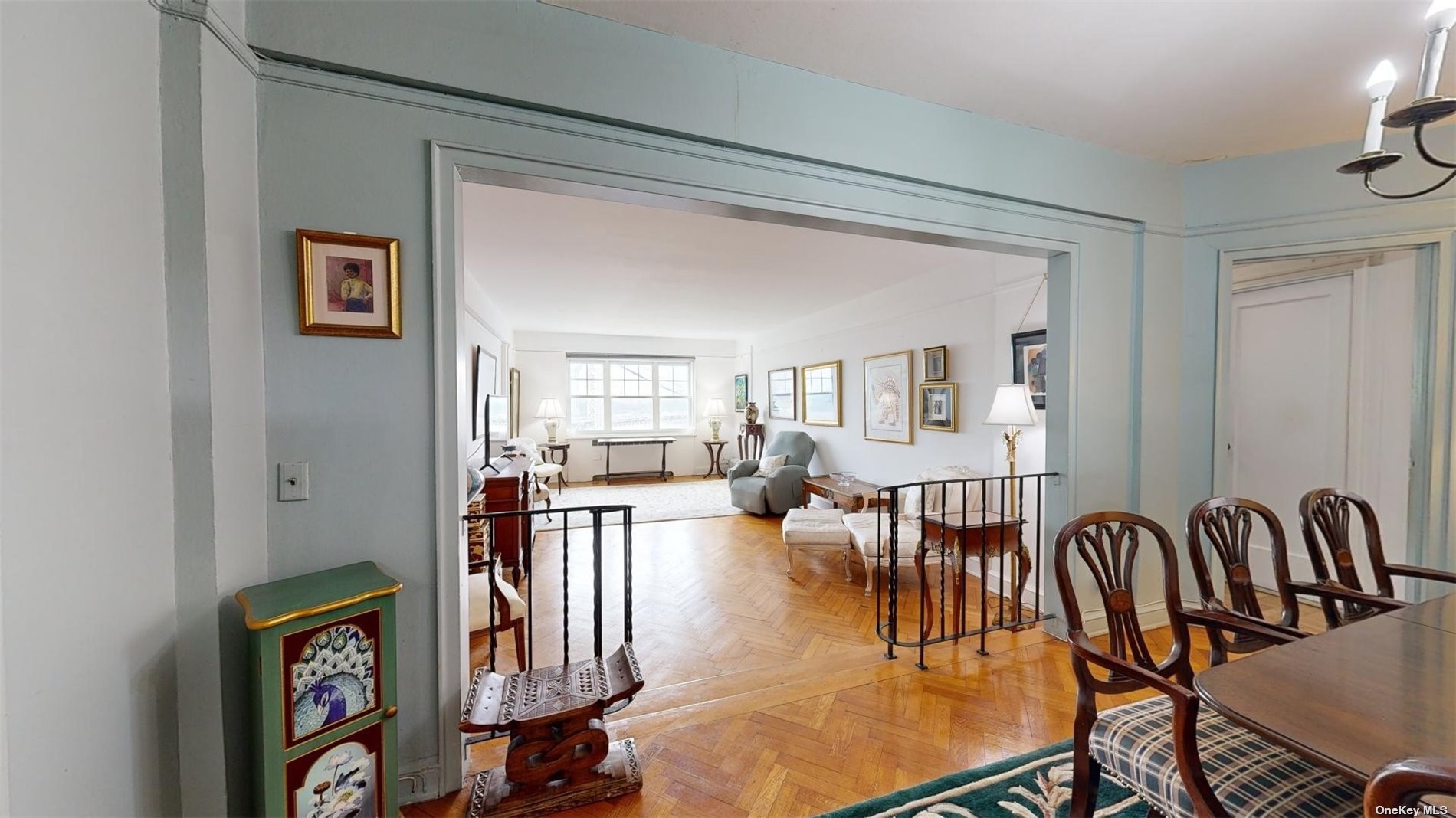 a living room with lots of furniture and paintings on the wall