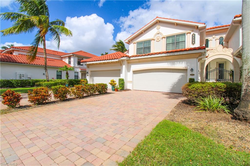 a front view of a house with a yard and garage