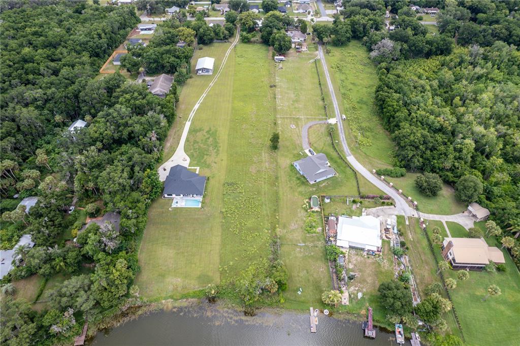 an aerial view of residential house with outdoor space and swimming pool