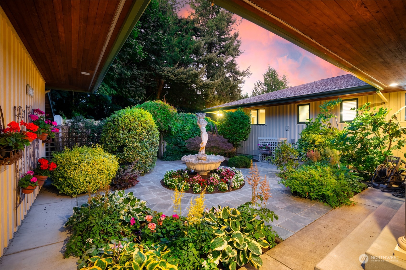 a front view of a house with a yard and outdoor seating