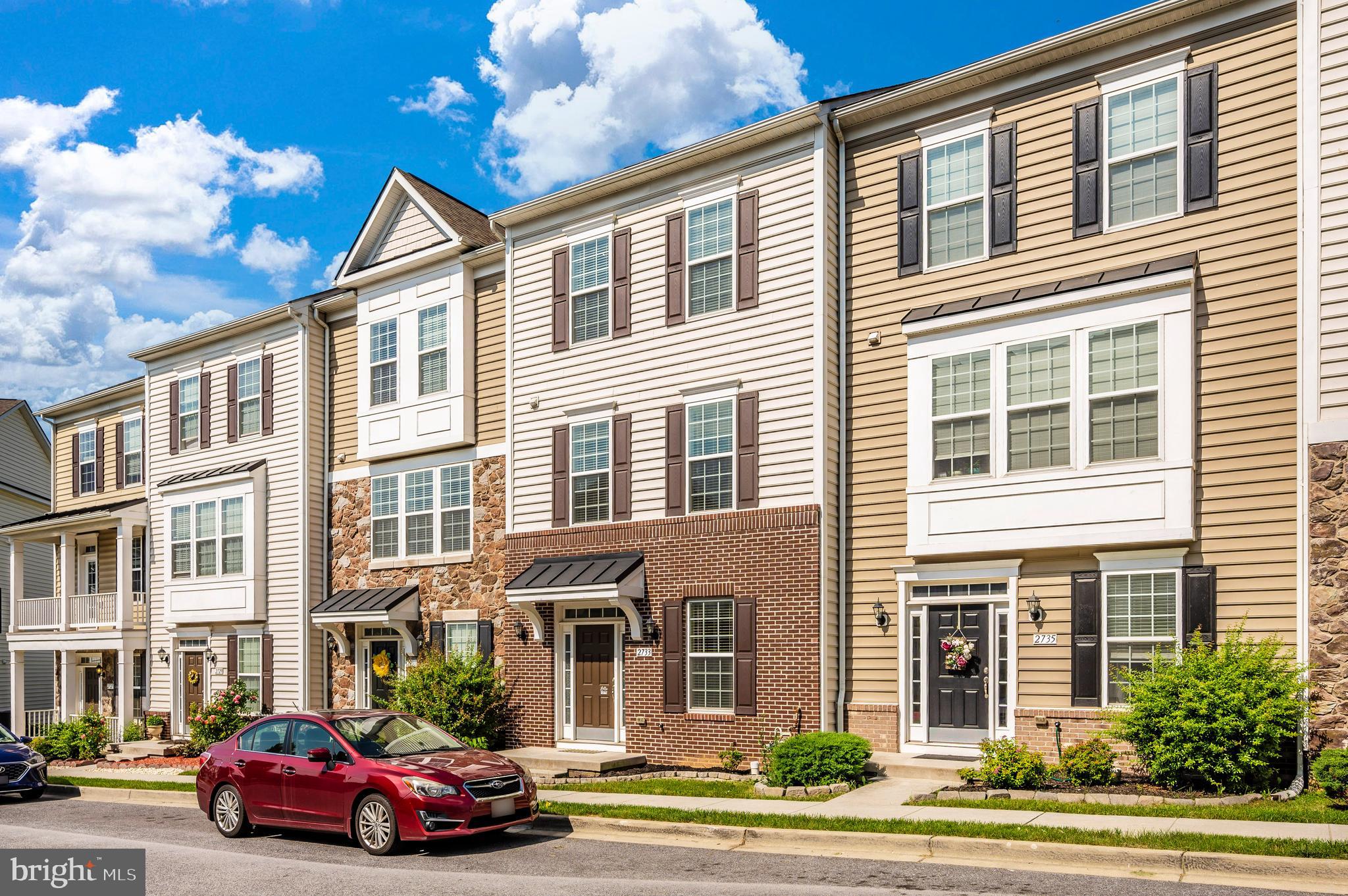 a front view of a residential apartment building with a yard