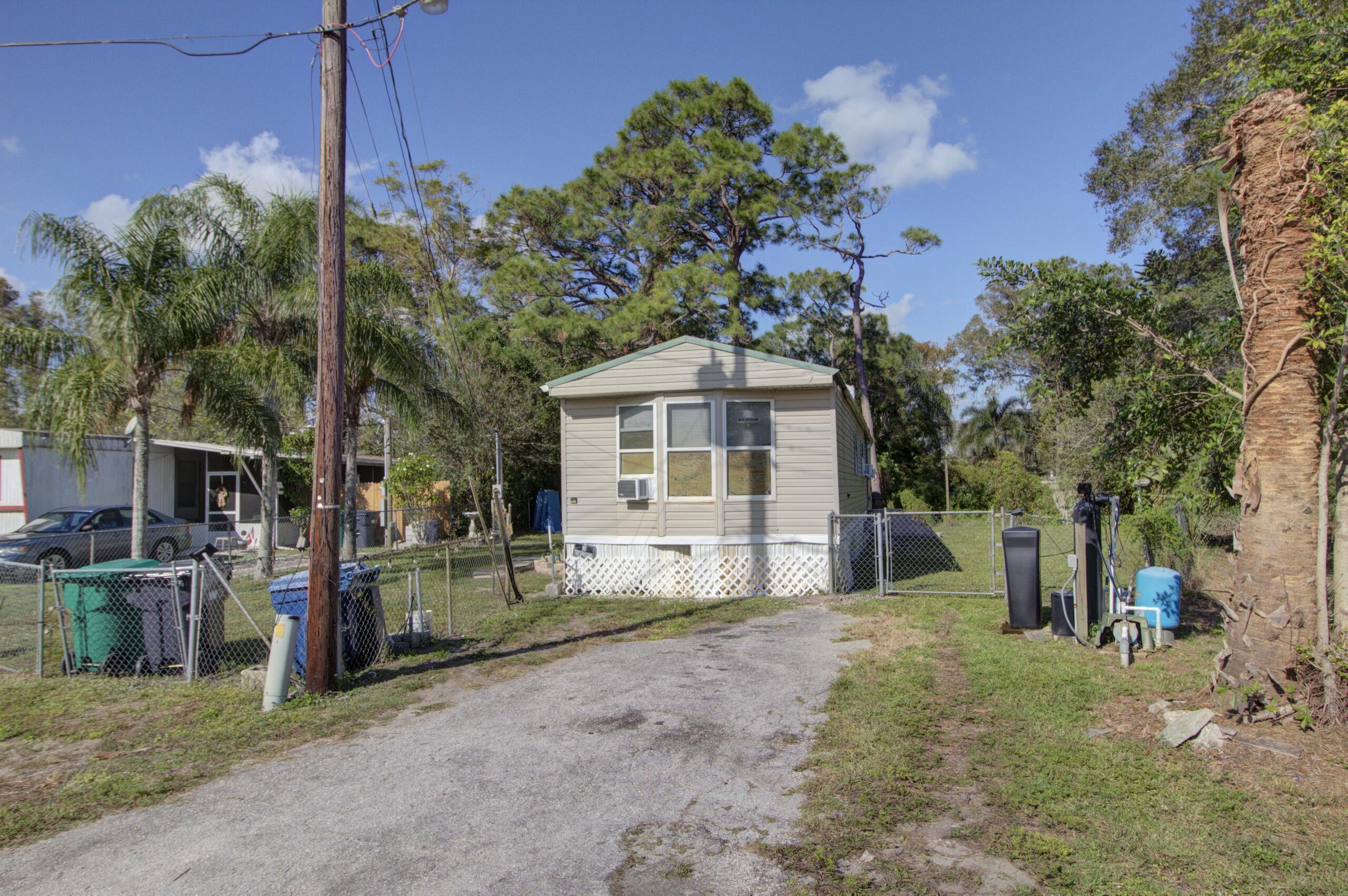 a view of a house with a small yard and tree