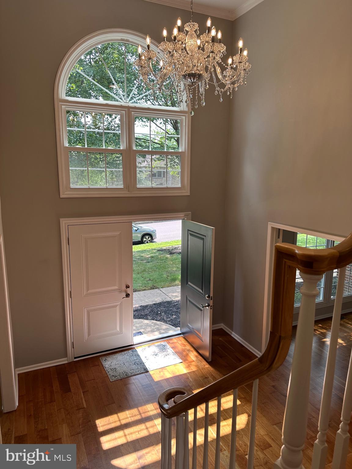 a view of a dining room with furniture and chandelier