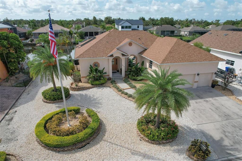 an aerial view of a house with yard and lake view