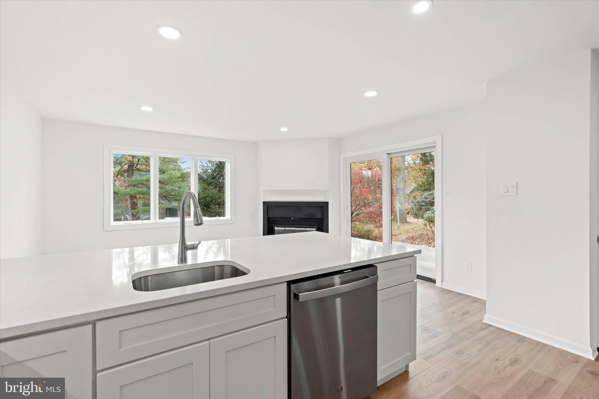 a kitchen with granite countertop a sink and a wooden floor