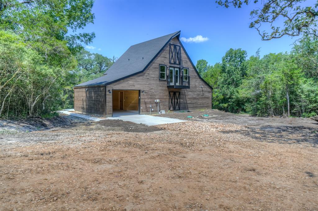 drive up view of new build home on 5 acres