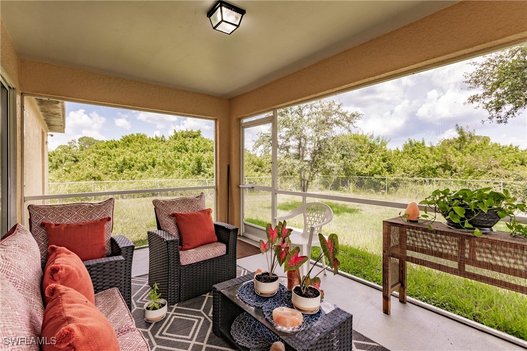 a living room with furniture and a floor to ceiling window