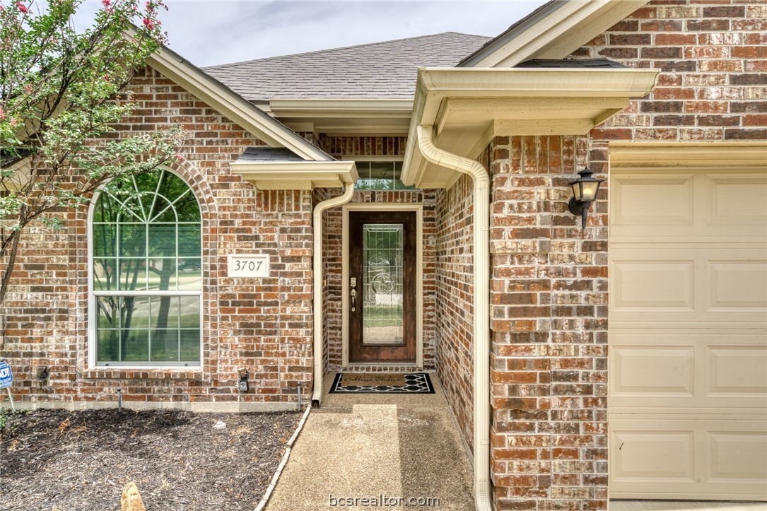 a front view of a brick house with a large window