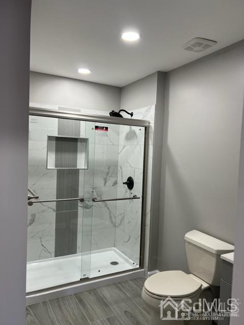 a bathroom with a toilet and a shower