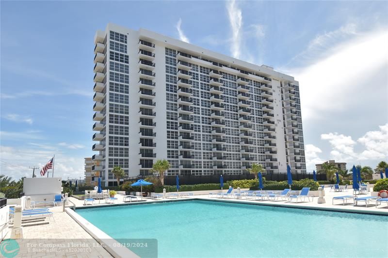 a view of pool with building exterior