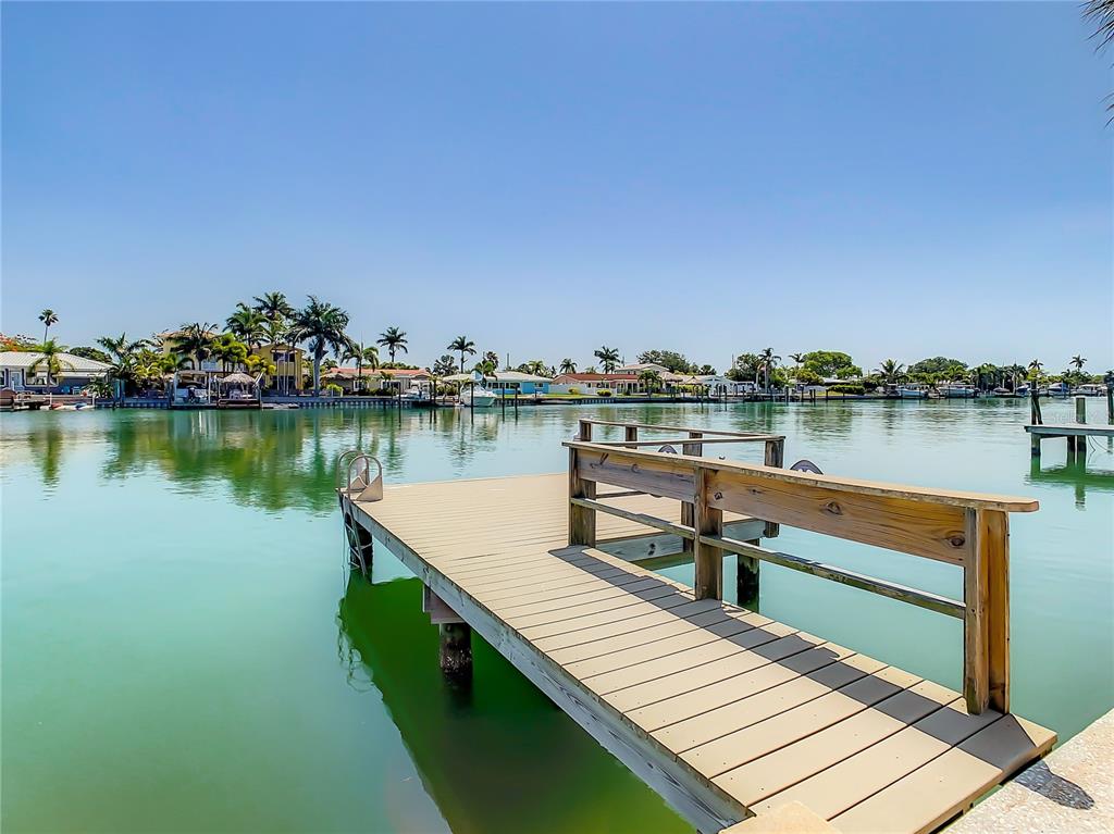 a view of a lake with wooden deck and city view