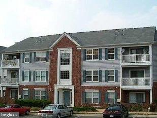 a front view of a residential apartment building with a yard