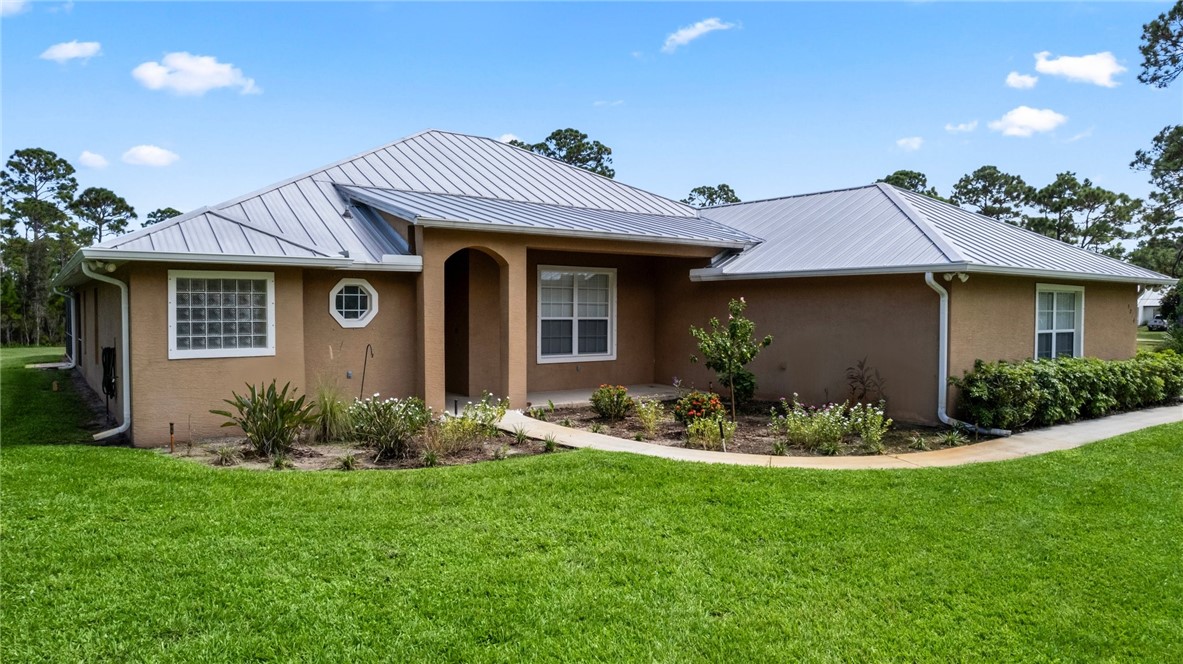 a front view of a house with garden