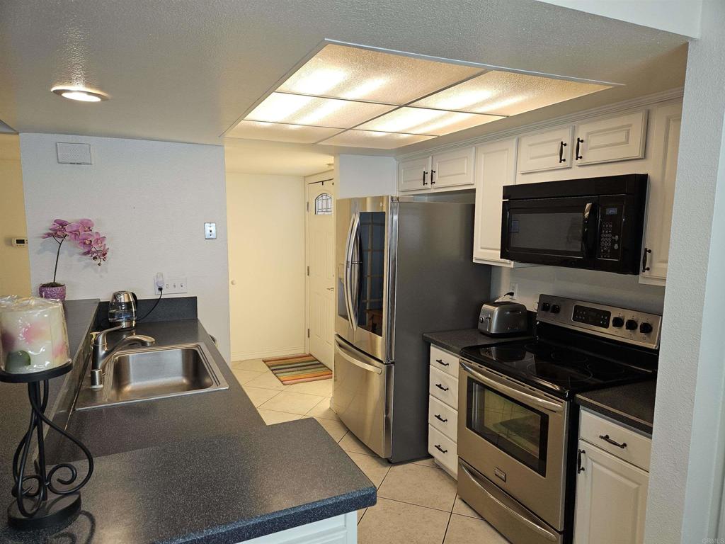 a kitchen with a refrigerator stove and sink