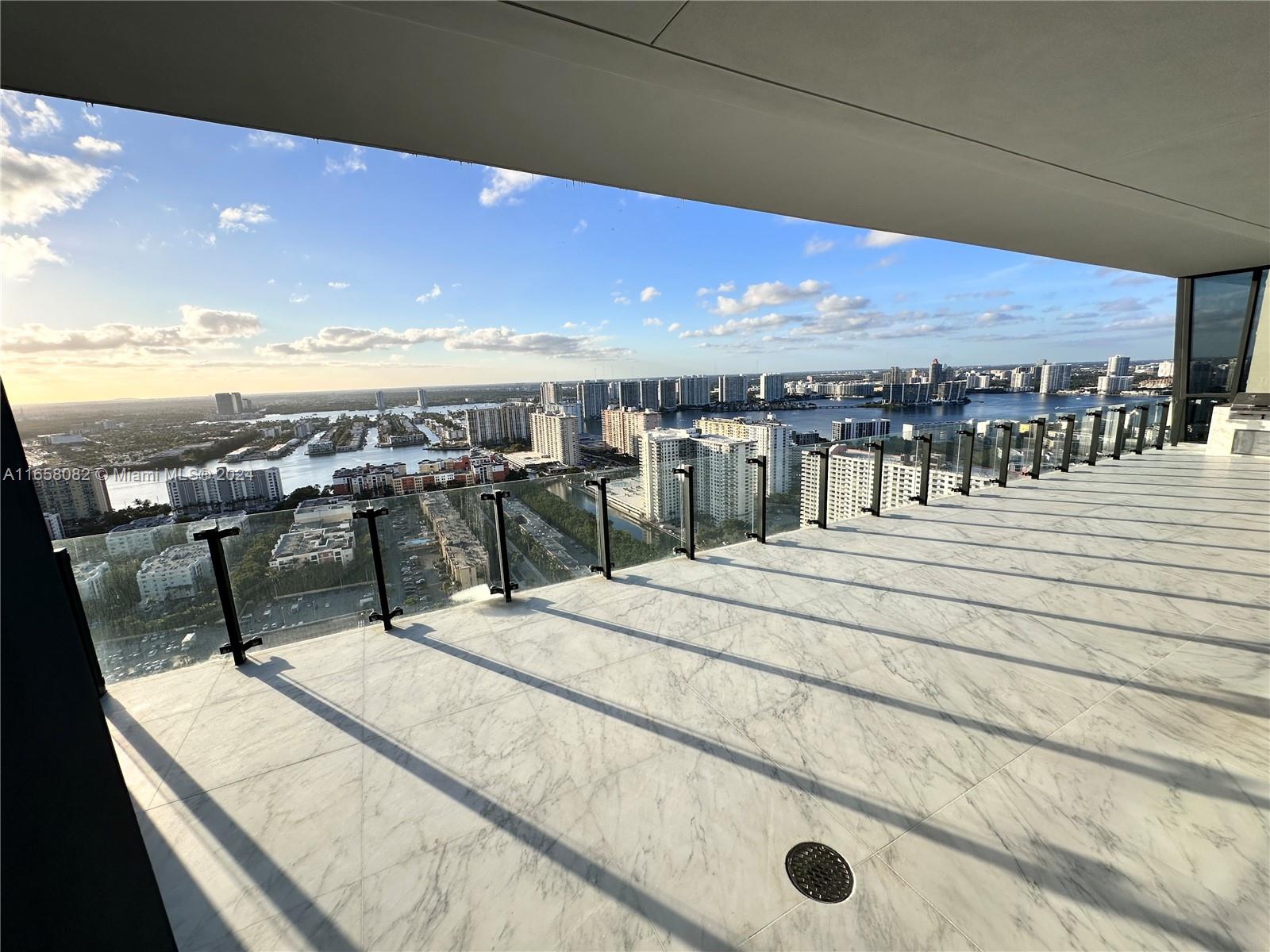 a balcony with furniture and city view