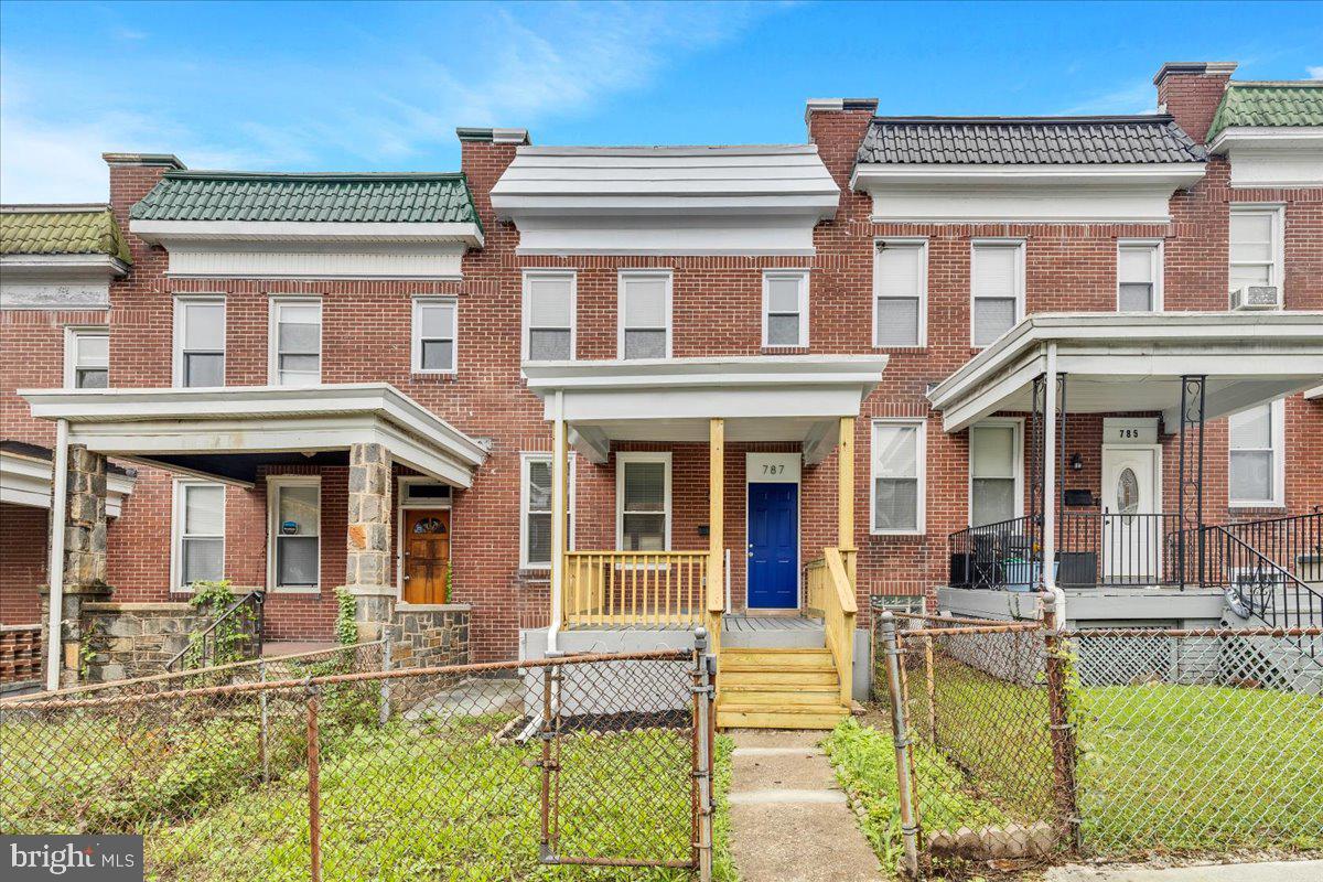 front view of a brick house with a large windows