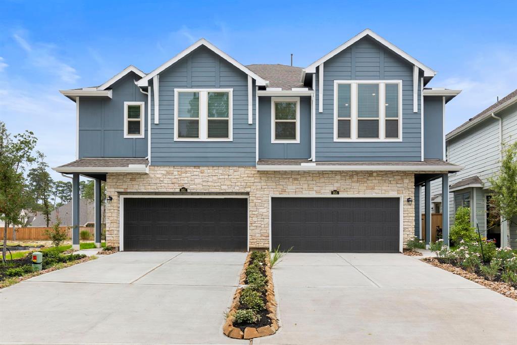 a front view of a house with yard and parking