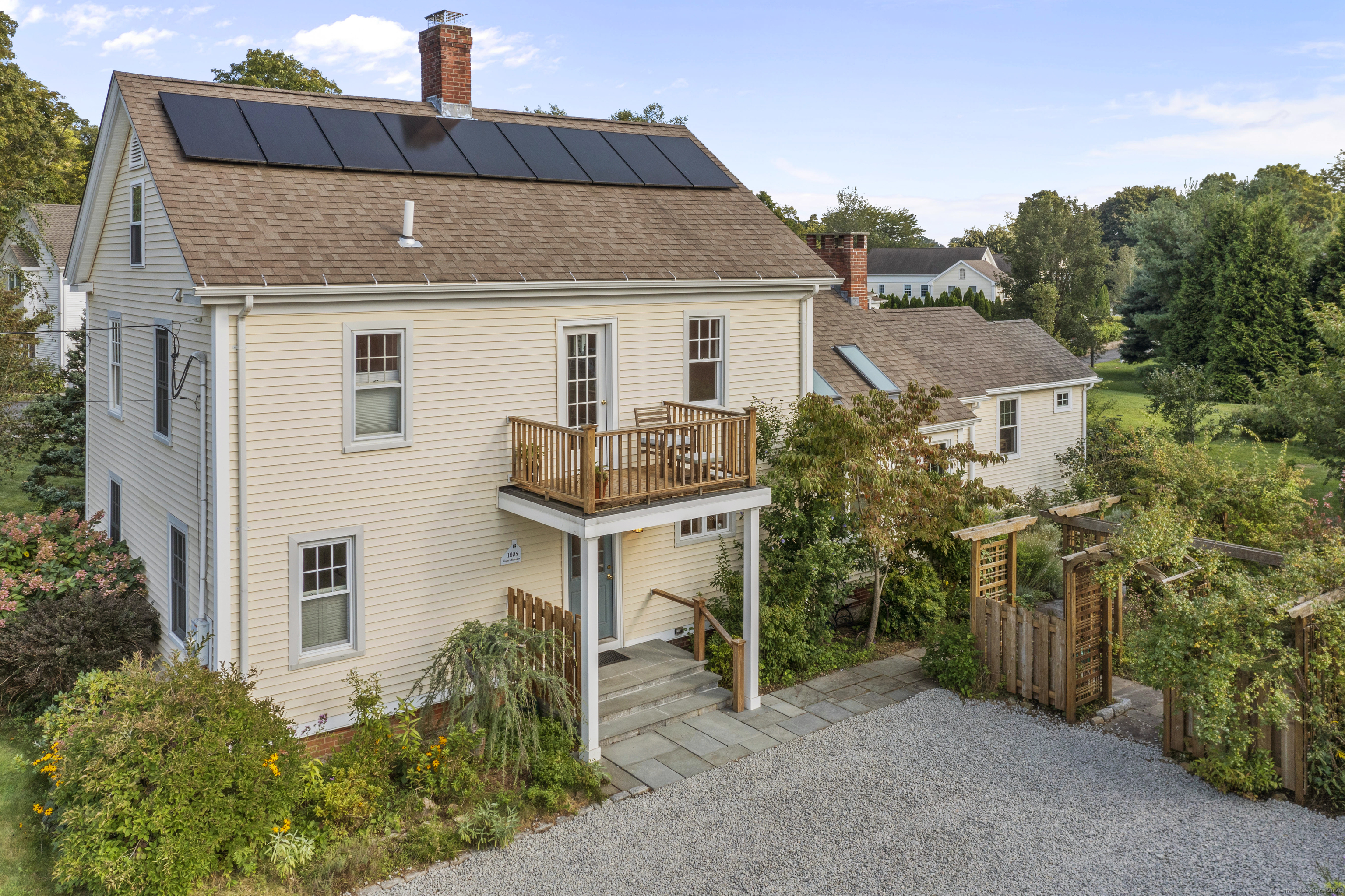 a aerial view of a house with a yard and potted plants