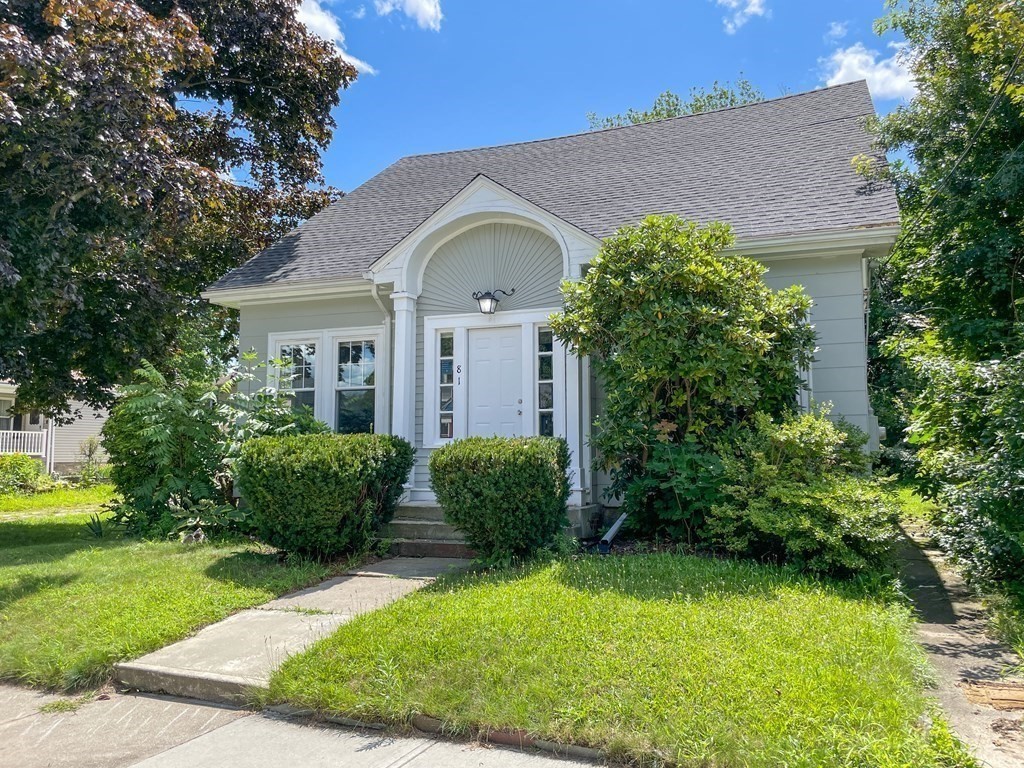 a front view of a house with a garden