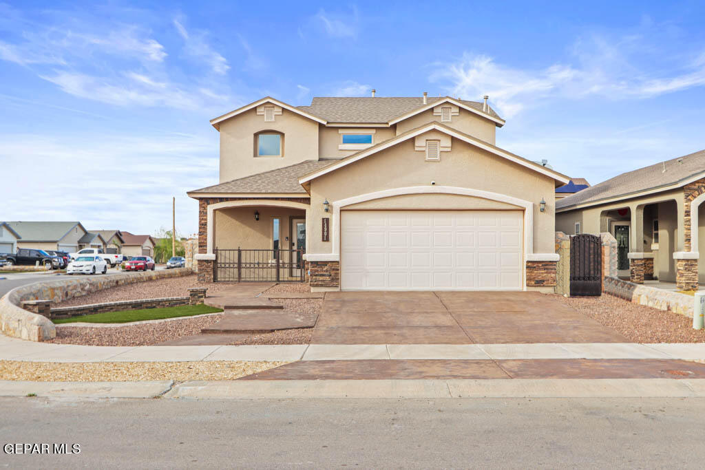 a front view of a house with a yard and garage