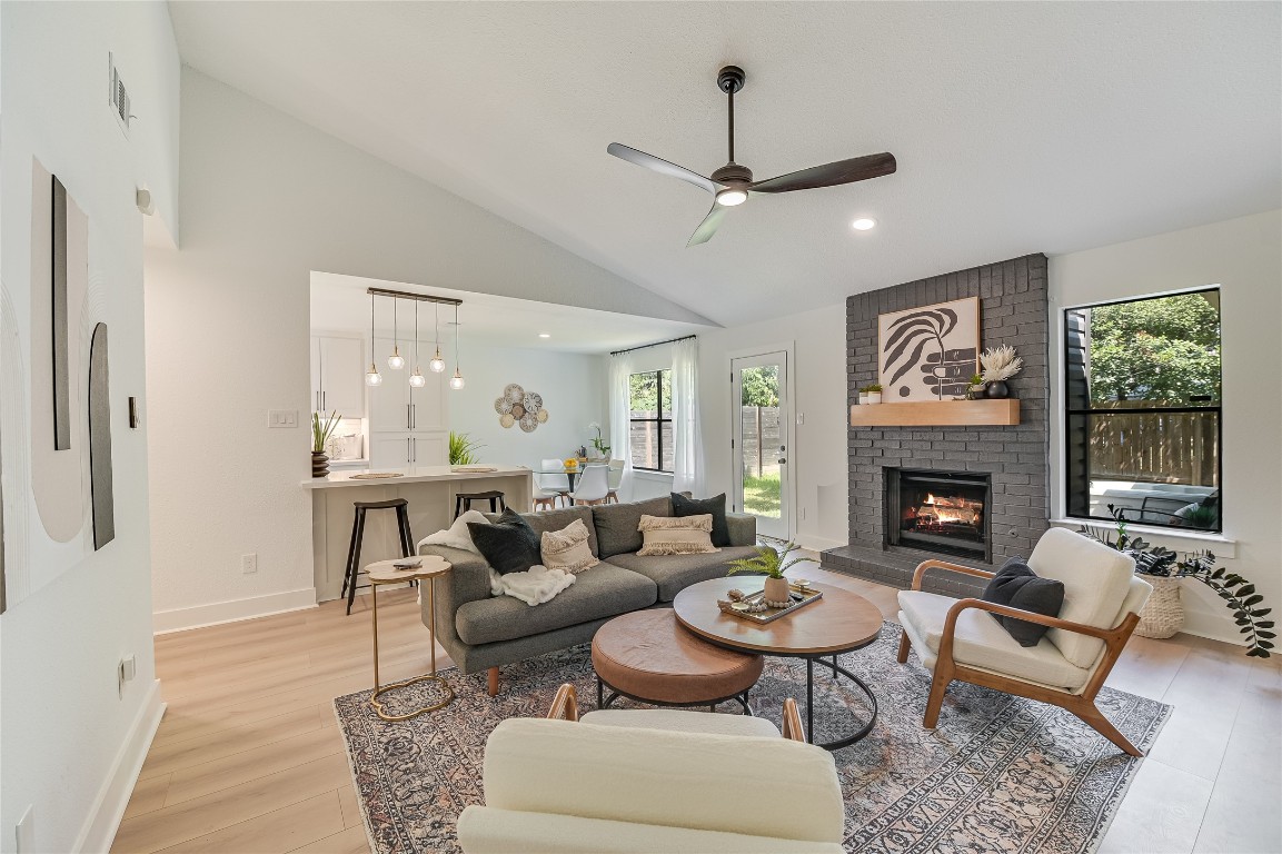 a living room with furniture and a fireplace