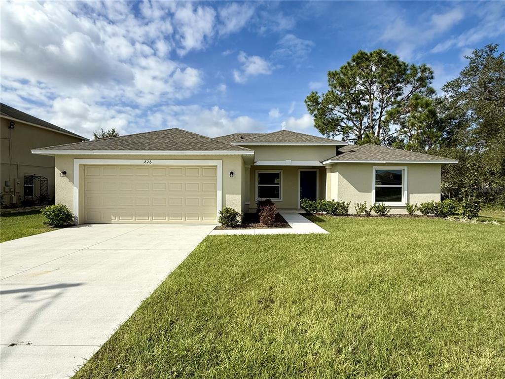 a front view of a house with yard and green space