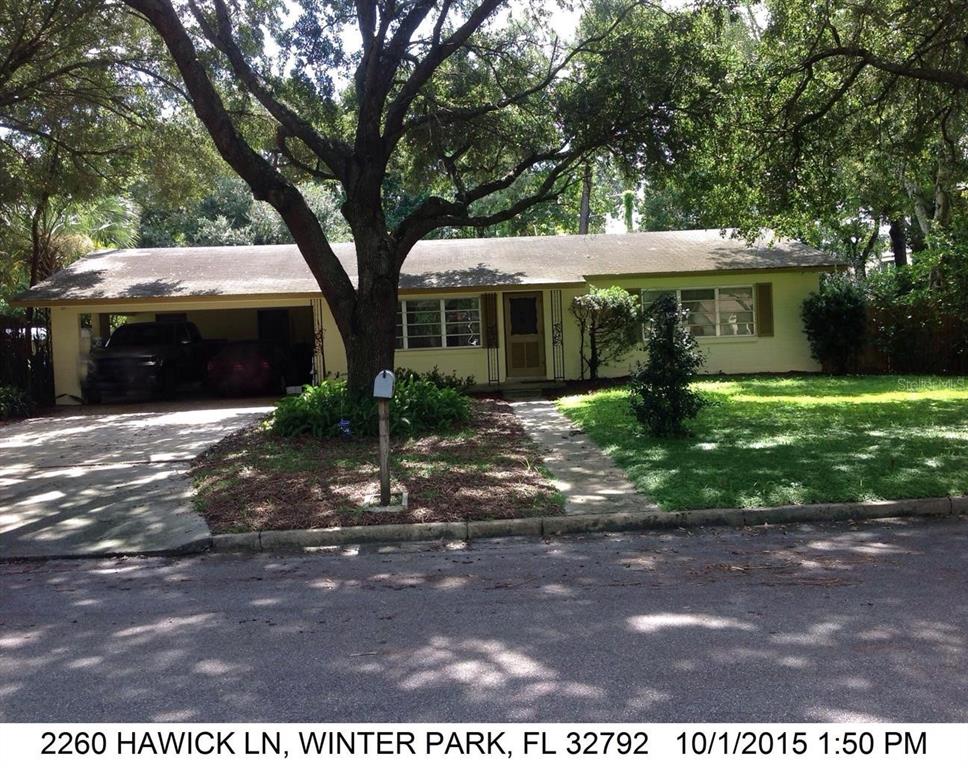 a view of house with a yard