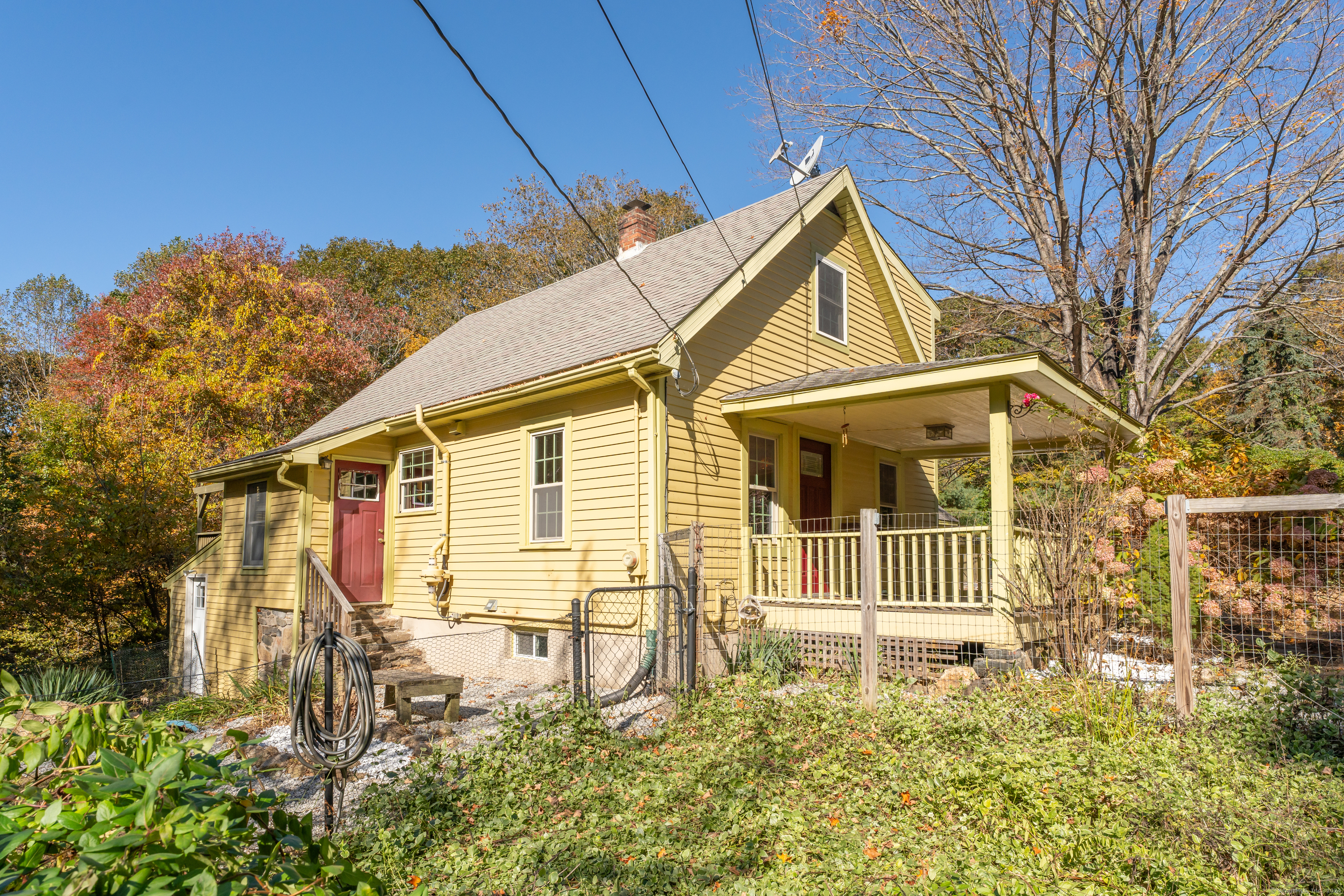 a view of a house with a small yard and wooden fence