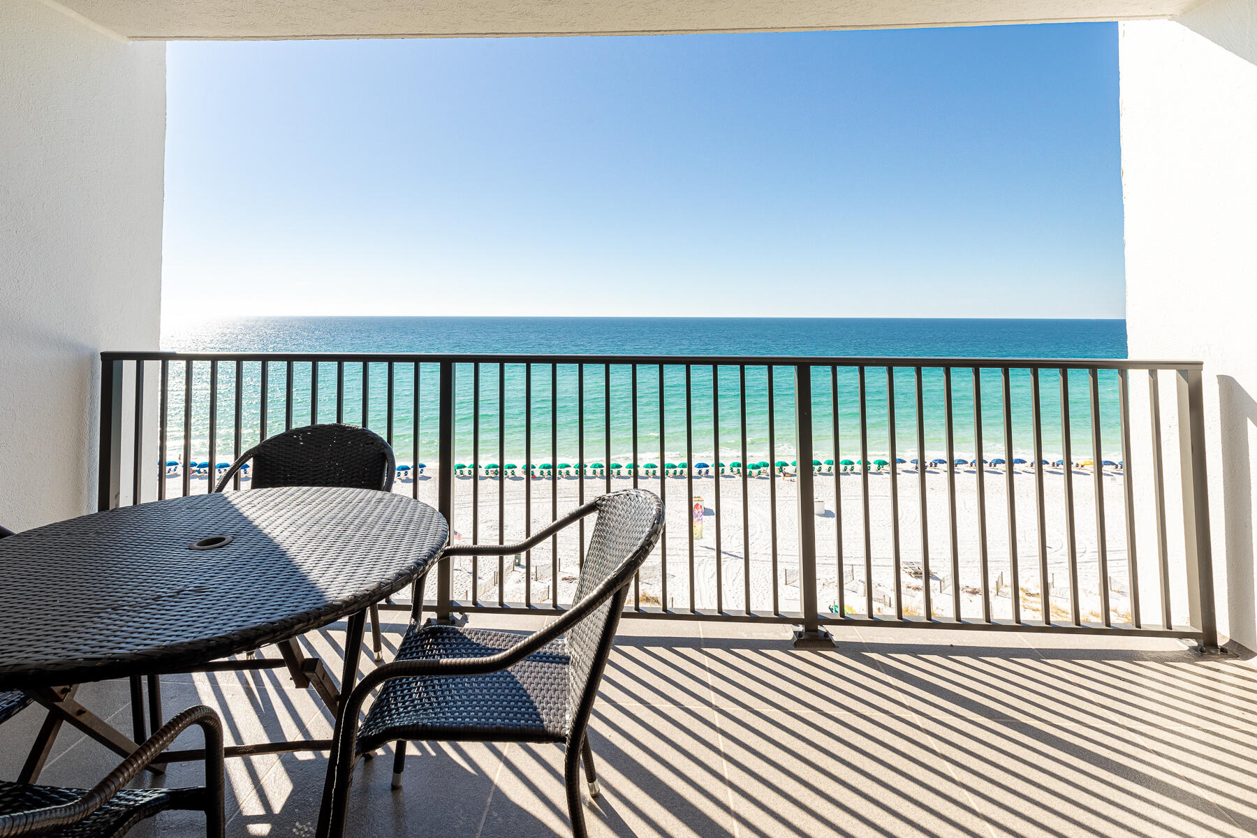 a view of a balcony with a table and chairs