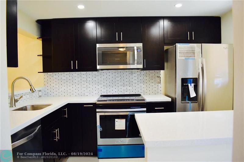 a kitchen with a sink and a refrigerator