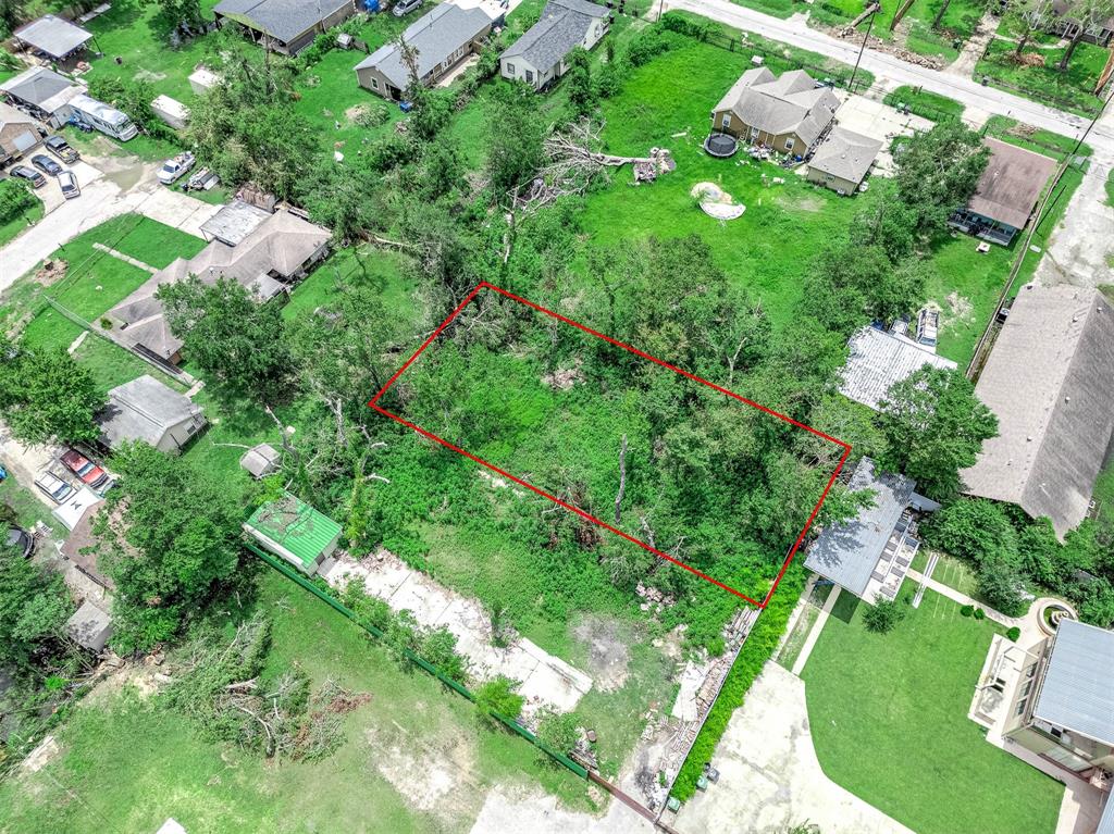 an aerial view of a house with a yard and outdoor seating