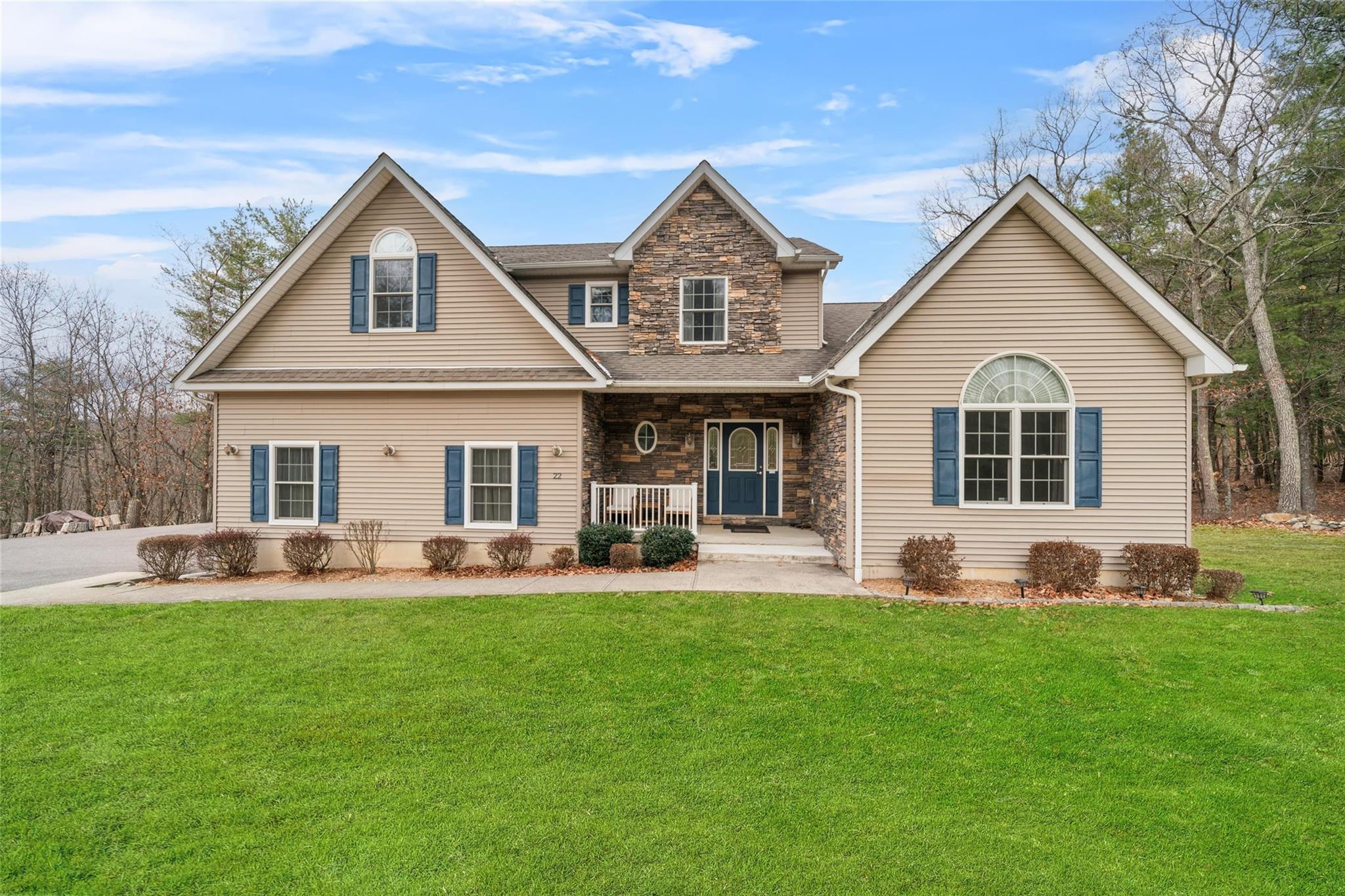 a front view of a house with a yard and patio