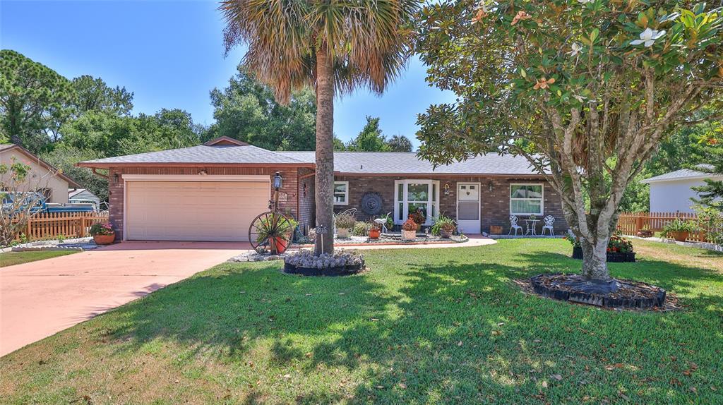 a front view of house with yard and outdoor seating