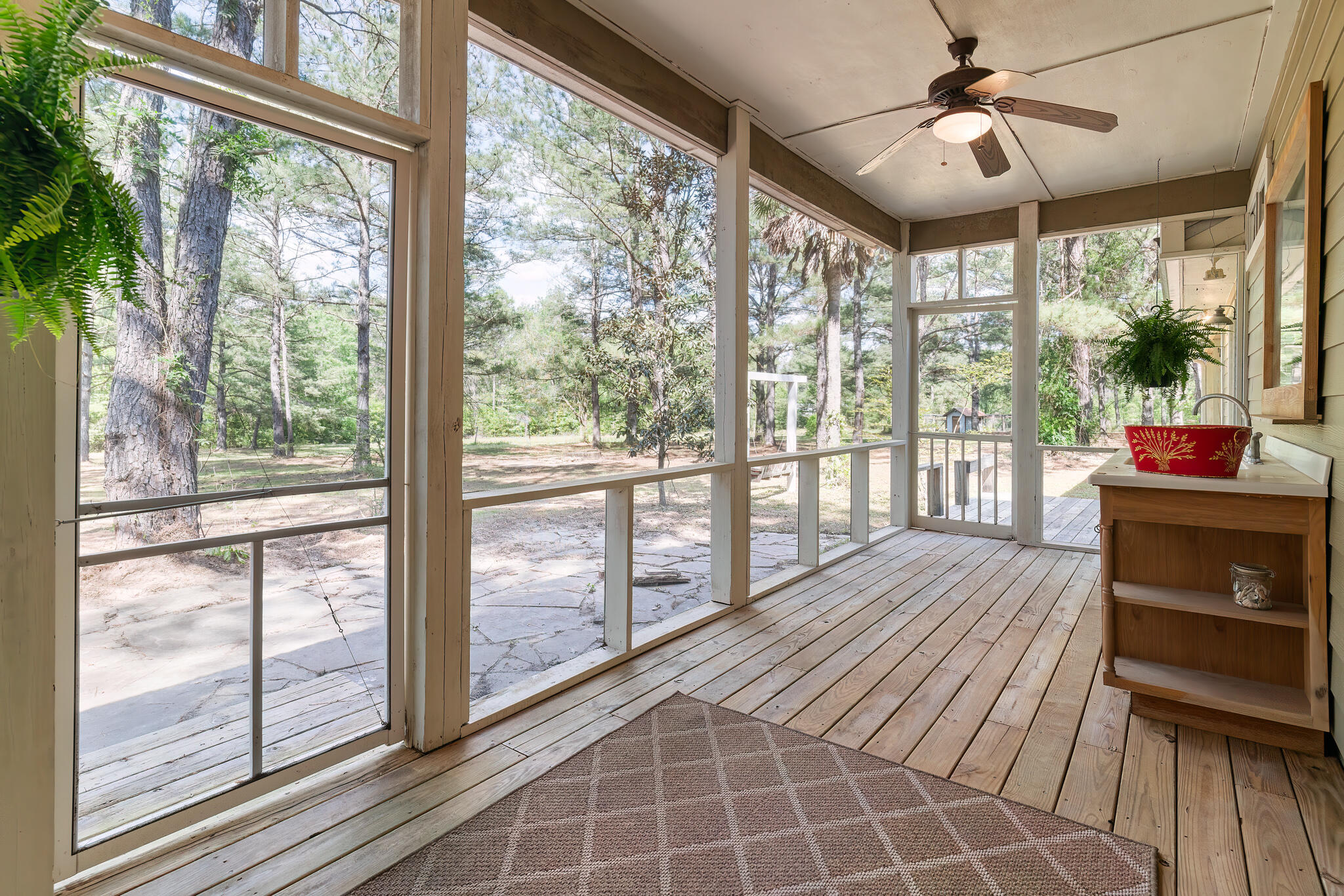 a view of a room with wooden floor and windows