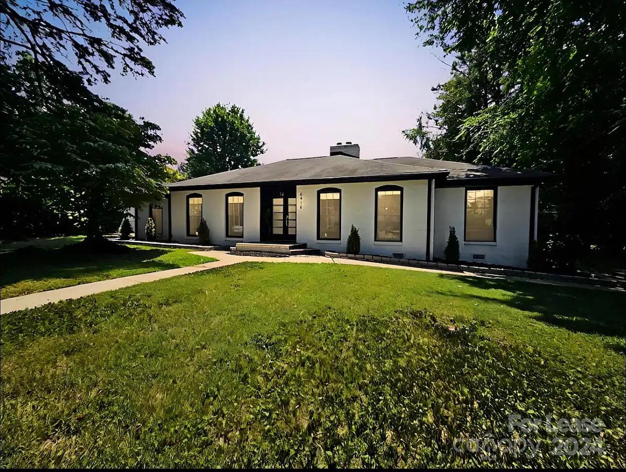 a front view of house with yard and green space