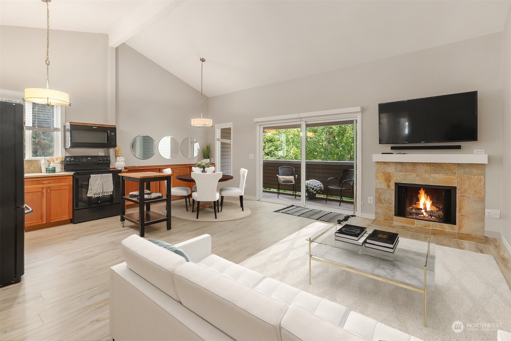 a living room with furniture a flat screen tv and a fireplace