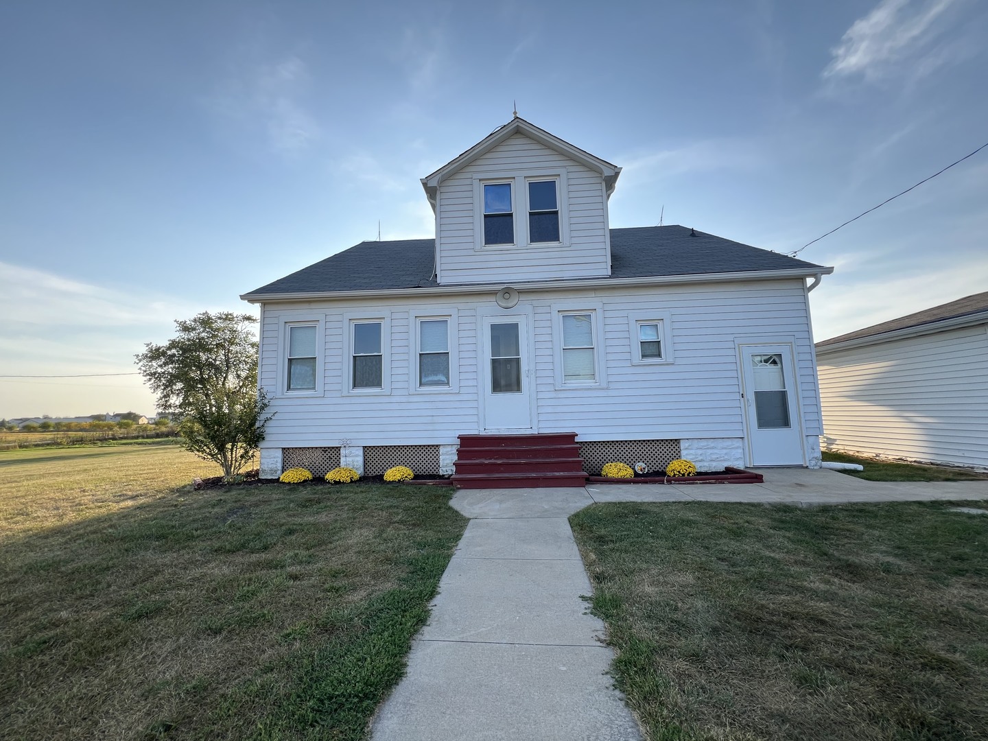 a front view of house with yard and outdoor seating